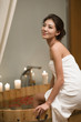 © Blue Jean Images - Portrait of beautiful young woman sitting on bathtub