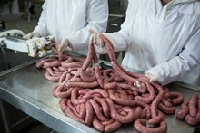 Butcher Holding Sausages