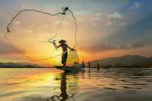 Asian Fishermen On Boat Fishing At Lake