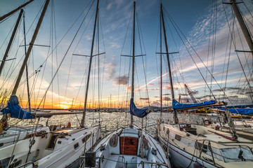 Wall Mural - Boats in Alghero harbor at sunset