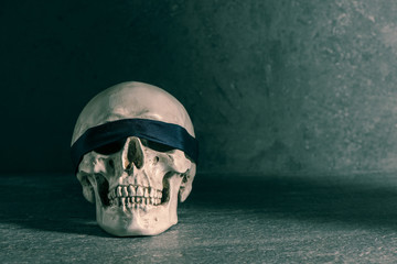 Human skull with blindfold. Concept of death, horror and execution. Spooky halloween symbol.