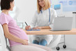 © Africa Studio - Gynecologist writing prescription to pregnant woman in hospital