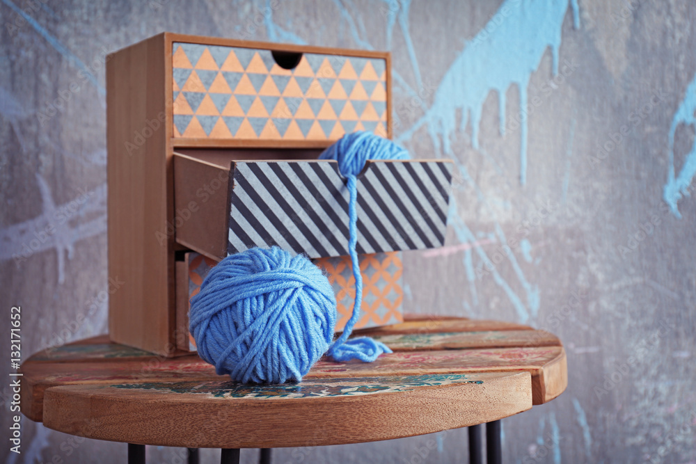 Ball of knitting yarn on wooden table