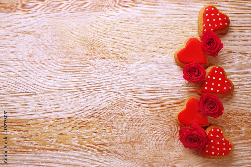Valentine heart cookies with roses on wooden background