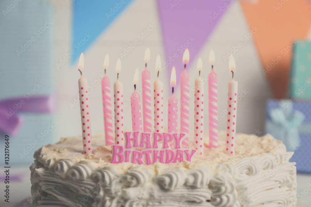 Birthday cake with candles on light background