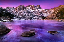 Sierra Buttes In Winter With Frozen Icy Lake And Snow.
