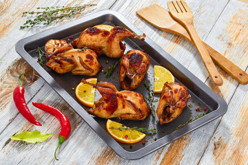 Poster - grilled whole quails with thyme and garlic in roasting dish