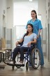 © WavebreakmediaMicro - Female nurse assisting patient on wheelchair in corridor