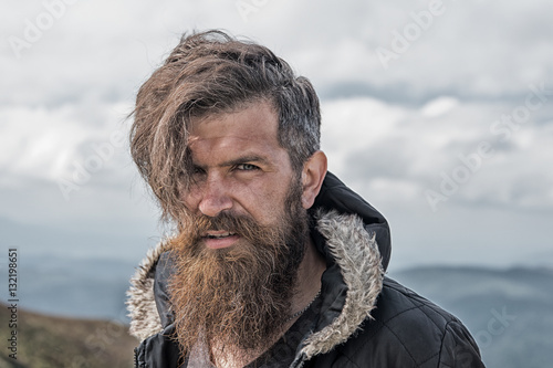 Fotografie, Obraz man hipster traveler with beard and moustache portrait on mountain