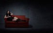 mistress lying down on red sofa