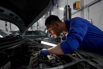 Sticker - mechanic man with lamp repairing car at workshop