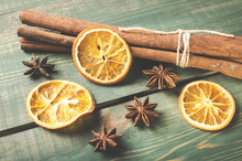 Dried Orange, Anise And Cinnamon Sticks On Green Wooden Table.