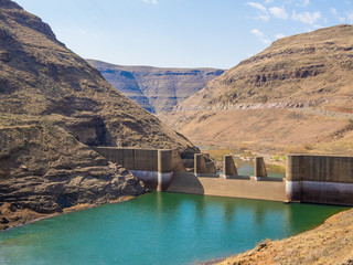 Downriver view of gorge and breakers at impressive Katse Dam hydroelectric power plant in Lesotho, Africa