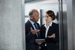 © WavebreakmediaMicro - Businessman with colleague in an elevator
