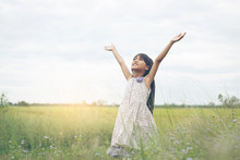 Cute Asian Girl Raised Hand At Meadow  Happily.