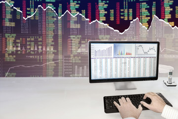 Fototapete - Man analyzing financial data and charts on computer 