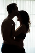 © DenisProduction.com - Man kissing woman's forehead. Couple standing in the dark. Run away from everything.
