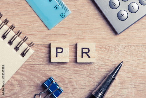 Fotografía PR abbreviation on table spelled with education game elements