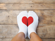  Feet Wearing White Socks With Red Heart Shape