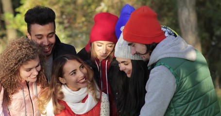 Sticker - Young People Group Using Tablet Computer Laughing Outdoors In Autumn Park, Mix Race Friends Slow Motion 60