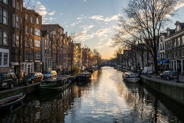 Wall Mural - Beautiful sunset over Amsterdam, The Netherlands, with water canals and crazy architecture