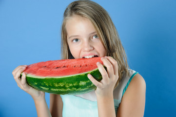 Charming girl has a juicy ripe watermelon.