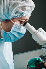 Wall Mural - close up view of scientist eye looking at microscope.