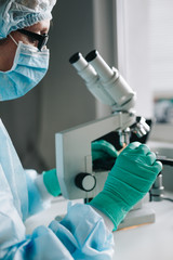 Wall Mural - close up crop view of scientist hands putting microscope glasses in special store box.