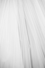 White long bridal dress with details of lace in showroom, textile, vertical black and white