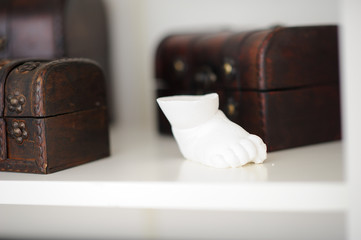 White souvenir on the background of wooden boxes, shallow focus