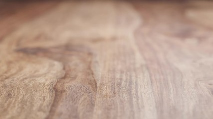 Wall Mural - clementine peels falling on wood table in slow motion, 180fps prores footage