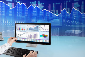 Fototapete - Man analyzing financial data and charts on computer 