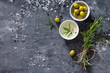 Black background cooking with olive oil, fresh herbs and spices,