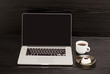 © somemeans - Open the laptop, mug of coffee and panna cotta on black wooden table, a lunch break