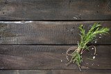 Fototapeta Dziecięca - Sprigs of rosemary tied with string on a wooden table. Copy spac