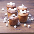 muffins with marmalade on wooden background
