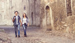 © Acronym - Couple of young travelers walking around old town