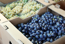 Cardboard Box With Juicy Grapes On Market, Closeup