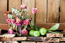 Green, Summer Apples And Dried Roses With Old Wood Texture