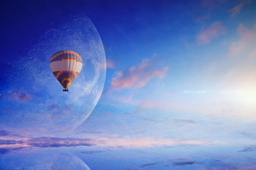 Wall Mural - hot air balloon in blue sky with rising full moon