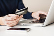 © kite_rin - Male hands holding credit card and using laptop. Online shopping concept
