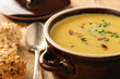Corn cream soup with bacon (chowder) on wooden background.