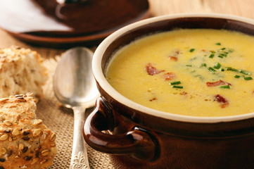 Wall Mural - Corn cream soup with bacon (chowder) on wooden background.