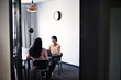© Andy Paul - Young businesswomen discussing with each other in office