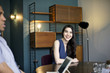 © Andy Paul - Woman smiling at business meeting