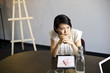 © Andy Paul - Japanese businesswoman leaning on a table during an office meeting