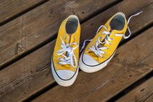 Cool Teenager Yellow Sneakers On Wooden Background