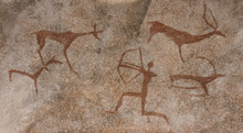 Drawing On A Rock Cave Wall Ocher Paint, Ancient Prehistoric Neanderthal Man. Man Surrounded By Prehistoric Animals, Head Of Intelligence, Radiance, Lord