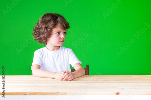 The Curly Haired Pretty Boy Looks Suspiciously Left Sitting At The