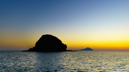 Wall Mural - Sunset at Pollara (Salina) looking towards ships and Filicudi an